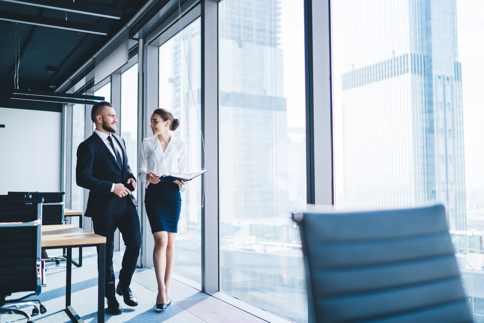 Executive talking to female assistant